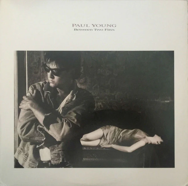 Paul Young - Between Two Fires (LP, Album, Car) (Very Good Plus (VG+))